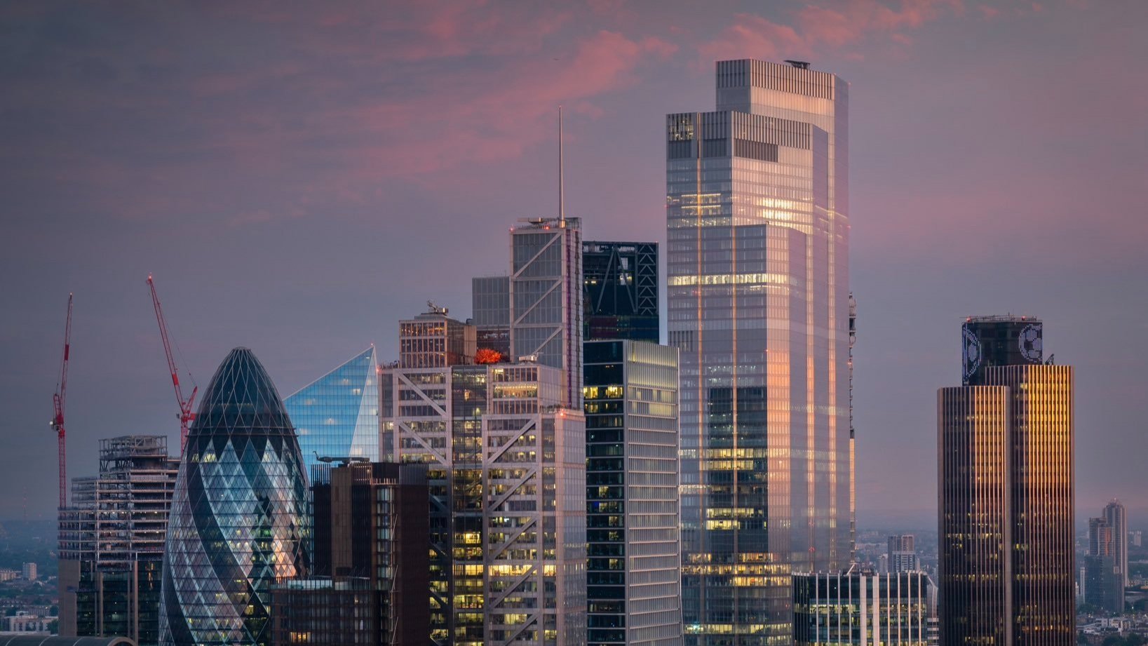 The London skyline at sunset showing the Gherkin, the Walkie Talkie and the Scalpel.